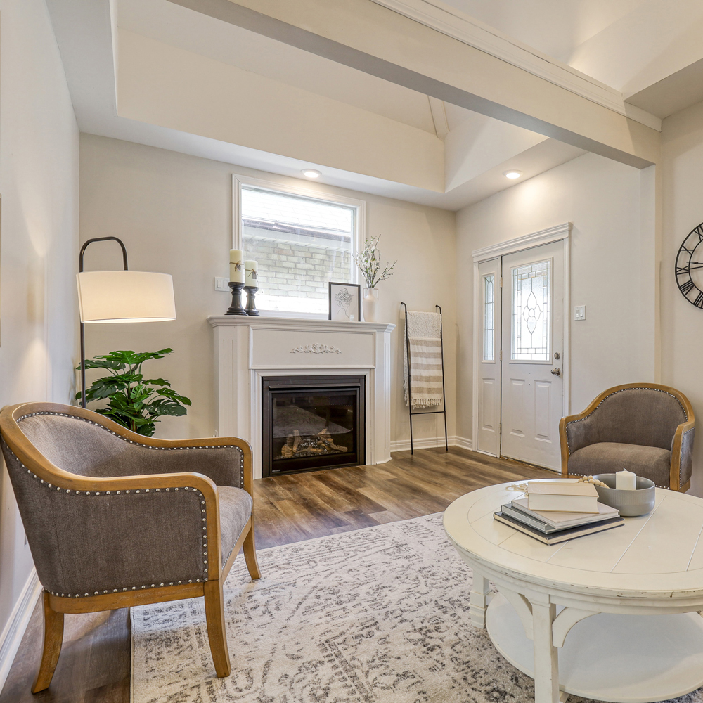 Renovated living room complete with electric fireplace and mantle